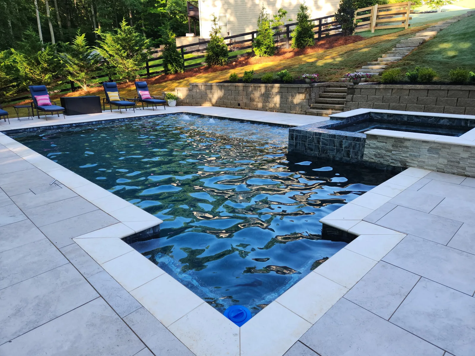 New pool with a raised spa and clean paver deck