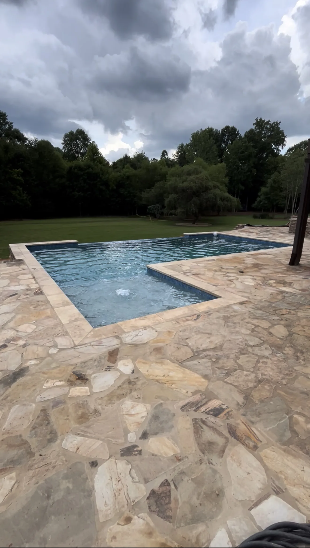 Finished pool and patio under an evening sky