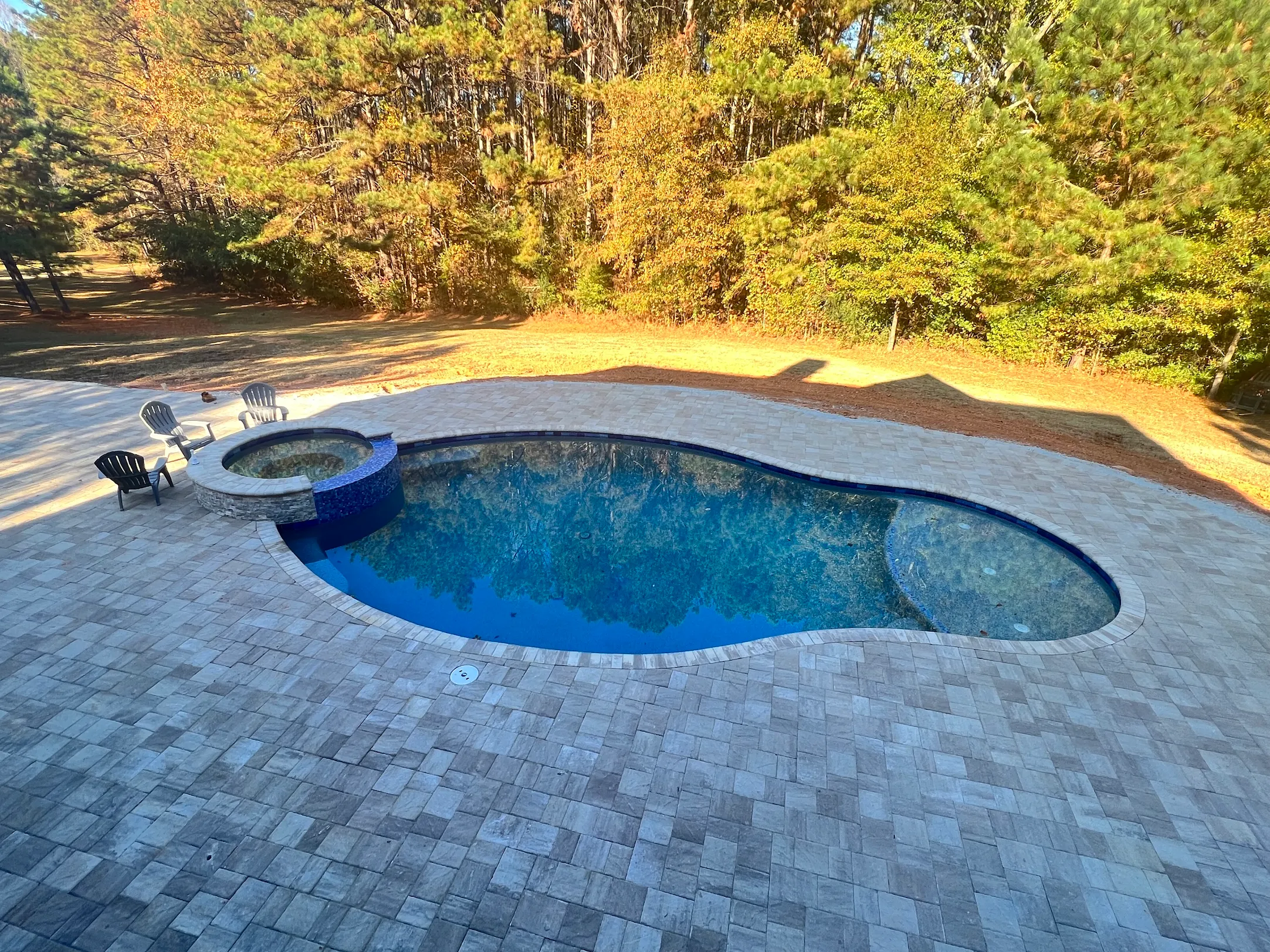 RutherfordMade custom pool and spa with paver patio and backyard lounge