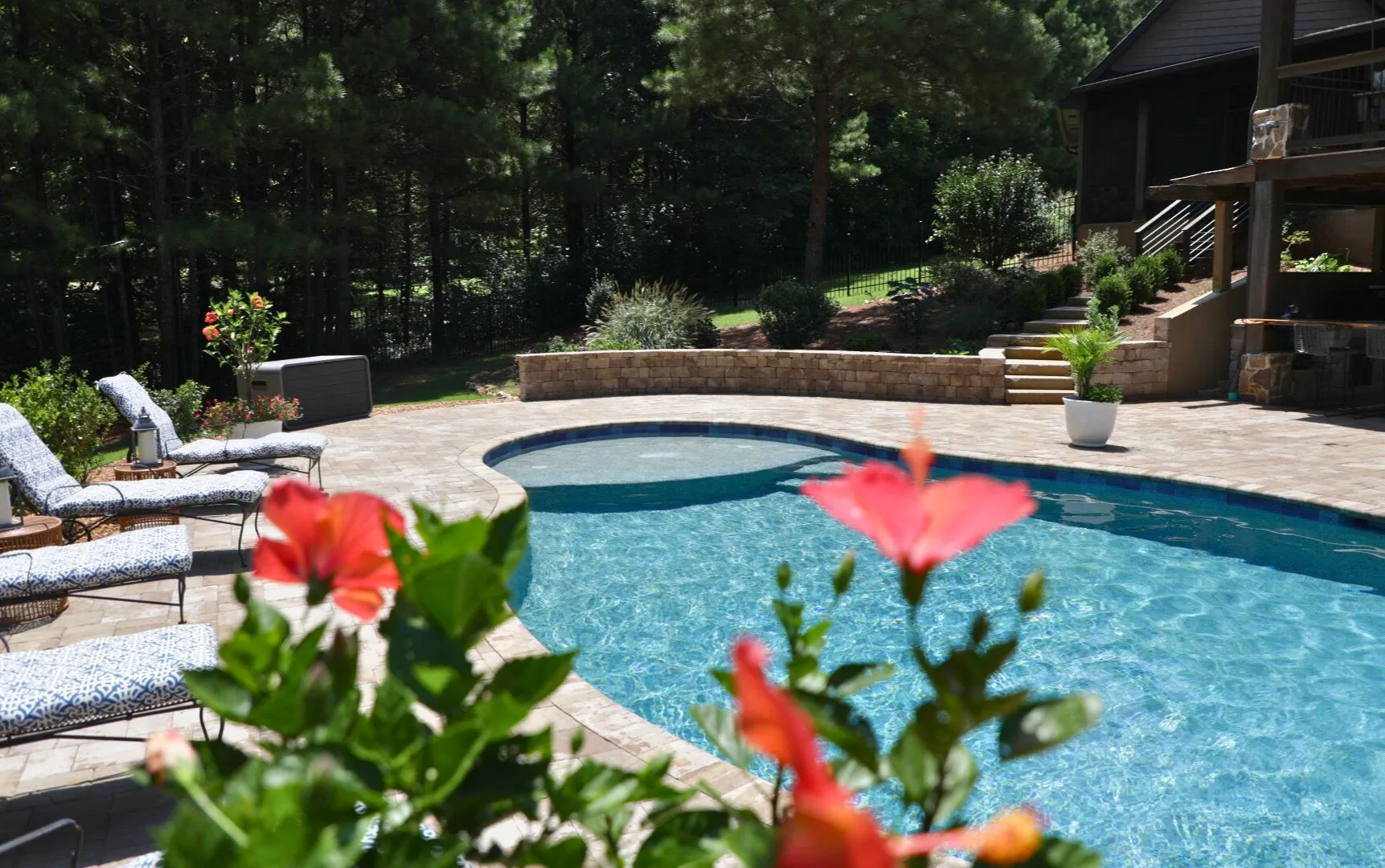 Dallas RutherfordMade custom pool with tanning ledge and stone surround