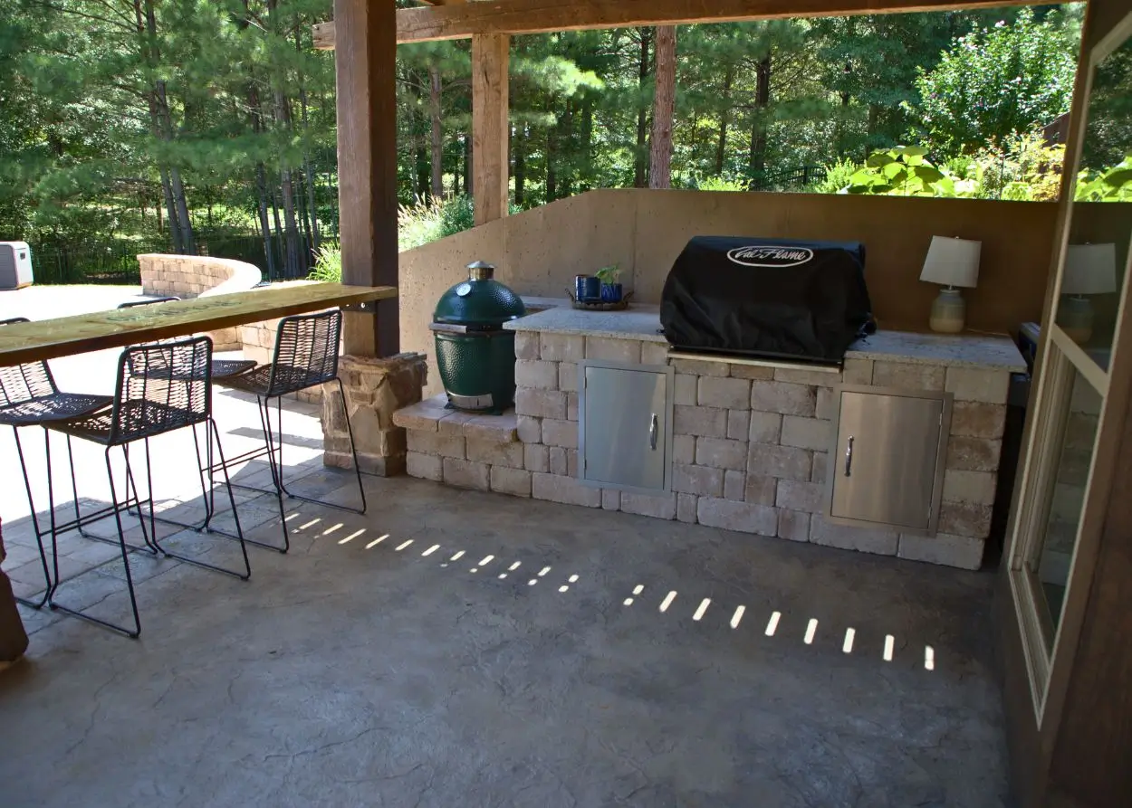 RutherfordMade covered outdoor kitchen with TV, lighting, and controls